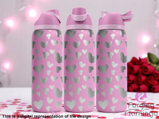 Three pink tumblers with flip-top lids, engraved with an all-over pattern of scattered hearts in various sizes, displayed against a romantic pink background with string lights, red roses, and heart-shaped confetti. Text below reads “This is a digital representation of the design.”
