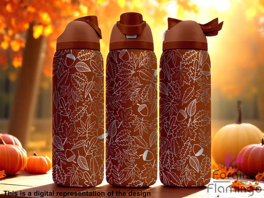 Three stainless steel tumblers with an autumn-themed design featuring an intricate pattern of leaves and acorns in a light engraved style over a warm brown background. The tumblers are set against a fall forest scene with orange foliage, pumpkins, and soft sunlight. Text at the bottom reads “This is a digital representation of the design.”