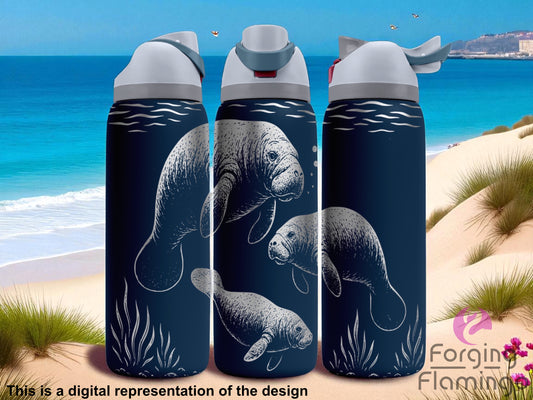 Three navy blue Owala tumblers featuring a laser-engraved underwater manatee design. Each tumbler displays detailed white engravings of manatees swimming among gentle wave lines and seagrass. The wraparound scene continues seamlessly across all three cups. Tumblers are topped with light gray lids and matching blue-gray spouts. The background shows a tropical beach with clear blue ocean, soft sand dunes, and a few birds in the sky. Forging Flamingo logo in the bottom right.