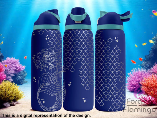 Three navy blue tumblers with flip-top lids, engraved with a mermaid design on one side and fish scale patterns wrapping around the rest of the tumbler, displayed against an underwater scene with coral reefs, fish, and beams of light. Text below reads “This is a digital representation of the design.”