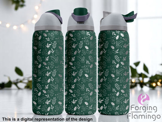 Three stainless steel tumblers with a dark green coating, featuring a seamless laser-engraved pattern of holly leaves, berries, mistletoe, and festive branches. The tumblers are displayed on a light surface with a soft holiday background, including blurred greenery and string lights. Text at the bottom reads “This is a digital representation of the design.”
