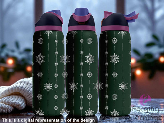 Three dark green Owala tumblers with laser-engraved vertical snowflake garland designs, displayed on a snowy windowsill with a cozy winter evening scene outside, including blurred lights and frost. Forging Flamingo logo appears in the bottom right corner.