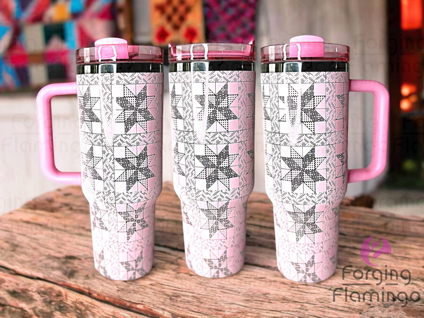 Composite image of a 40oz light pink tumbler with onyx engraving, featuring Forging Flamingo's 8 Point Star Quilt design. Displayed from multiple angles to highlight intricate quilt block star patterns in a seamless, heirloom-inspired wrap. Part of our Bargain Bin collection.