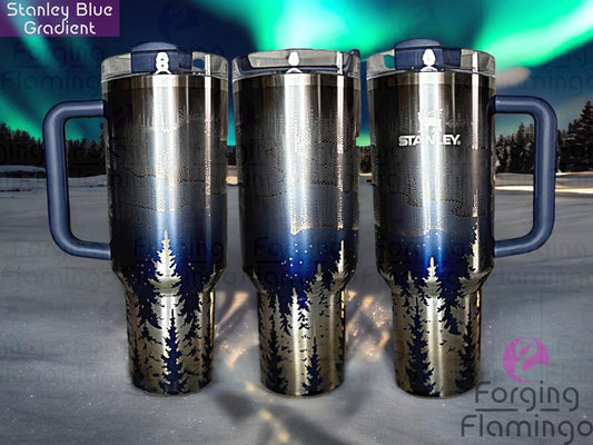 Composite image of a single Non-Branded blue gradient tumbler engraved with Forging Flamingo's Northern Lights with Trees design, shown from multiple angles to showcase radiant aurora bands above detailed tree lines and mountain peaks in a seamless wrap.