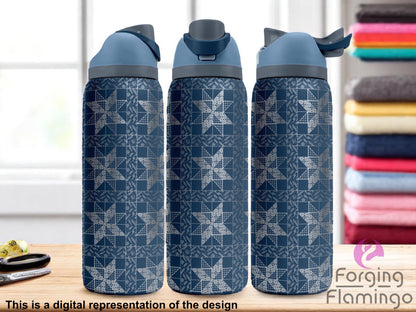 Three navy blue Owala tumblers with a full-wrap laser-engraved 8-point star quilt pattern, displayed on a wooden surface in a laundry room setting with folded colorful towels in the background. Forging Flamingo logo appears in the bottom right corner.
