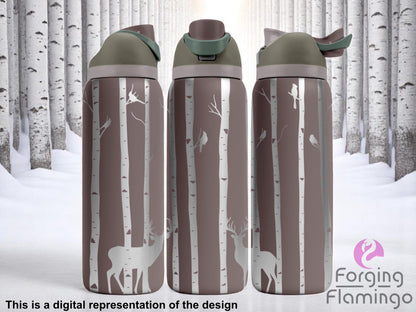 Three stainless steel tumblers with olive and taupe flip-top lids, engraved with a woodland scene of slender birch trees, perched birds, and deer silhouettes. The background features a snowy birch forest, creating a wintry, nature-inspired aesthetic. Text below reads “This is a digital representation of the design.”
