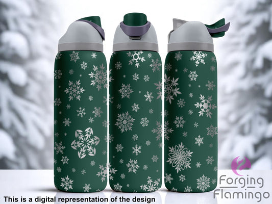 Three dark green stainless steel tumblers featuring an all-over laser-engraved snowflake design. The snowflakes vary in size and style, scattered across the entire surface of each cup. The background shows a blurred winter scene with snow-covered trees. Text at the bottom reads “This is a digital representation of the design.”
