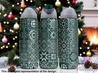 Three green tumblers with flip-top lids, engraved with a patchwork of geometric snowflake and star tile patterns, displayed in front of a Christmas tree and fireplace decorated for the holidays. Text below reads “This is a digital representation of the design.”
