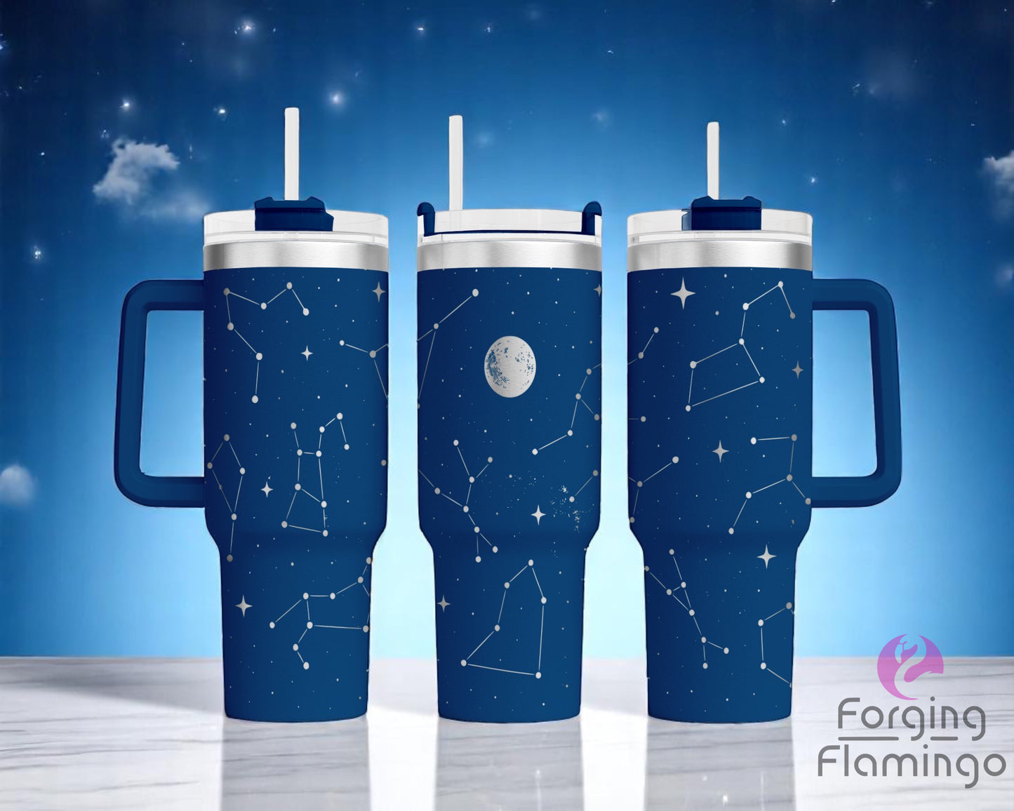 Three blue handled tumblers with white straw lids, displayed on a white marble surface against a starry night sky background. The tumblers feature a laser-engraved constellation design in silver metal, with various star patterns and a full moon illustration in the center tumbler. The engraving wraps around the cups, giving the appearance of a night sky filled with constellations. The Forging Flamingo logo appears in the lower right corner.
