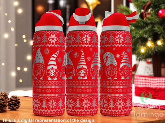 Three red tumblers with flip-top lids, engraved with Christmas gnome designs, snowflakes, and Nordic sweater patterns, displayed on a festive holiday table with Christmas lights and tree in the background. Text below reads “This is a digital representation of the design.”
