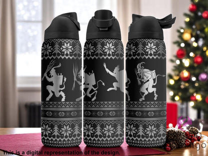 Three black tumblers with flip-top lids, engraved with Krampus figures and Nordic sweater patterns, featuring snowflakes, pine trees, and geometric designs, displayed on a holiday table with a Christmas tree in the background. Text below reads “This is a digital representation of the design.”

