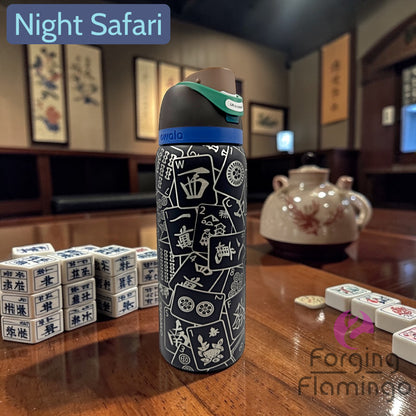 Water bottle with decorative design on a table with gaming pieces, in a room setting.