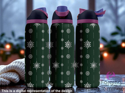 Three dark green Owala tumblers with laser-engraved vertical snowflake garland designs, displayed on a snowy windowsill with a cozy winter evening scene outside, including blurred lights and frost. Forging Flamingo logo appears in the bottom right corner.
