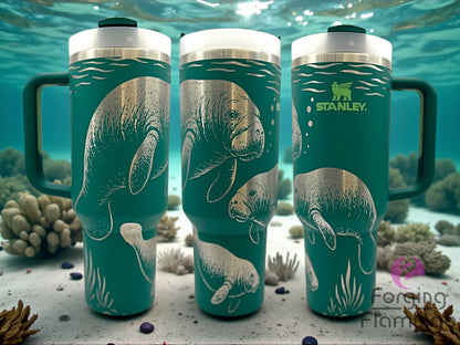 Three green Stanley mugs with manatee designs on a coral reef background