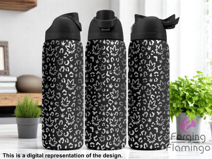 Three black tumblers with flip-top lids, engraved with a pattern of cannabis leaves and leopard print spots, displayed on a modern kitchen counter with small potted plants and books in the background. Text below reads “This is a digital representation of the design.”

