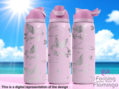 Three pastel pink Owala tumblers with laser-engraved flying pigs, clouds, and stars, displayed against a bright tropical beach backdrop with blue skies and ocean. Forging Flamingo logo appears in the bottom right corner.
