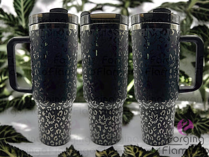 Composite image of a 40oz black tumbler with onyx engraving, featuring Forging Flamingo's Cannabis Leopard design. Shown from multiple angles to highlight marijuana leaves integrated into a bold leopard print pattern in a seamless wrap. Part of our Bargain Bin collection.
