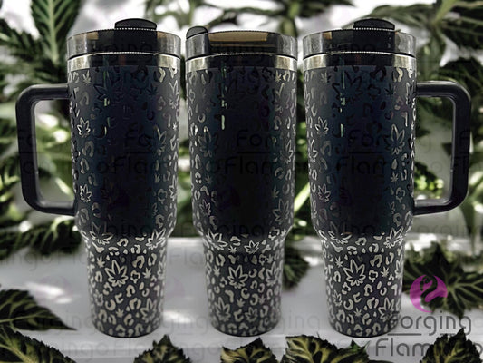 Composite image of a 40oz black tumbler with onyx engraving, featuring Forging Flamingo's Cannabis Leopard design. Shown from multiple angles to highlight marijuana leaves integrated into a bold leopard print pattern in a seamless wrap. Part of our Bargain Bin collection.