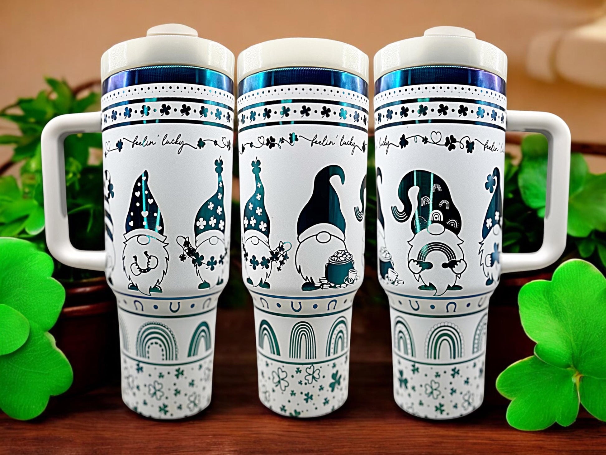Composite image of a 40oz white tumbler with green engraving, featuring Forging Flamingo's Lucky Gnomes design. Displayed from multiple angles to highlight shamrocks, gnomes, and festive St. Patrick's Day details in a seamless wrap. Part of our Bargain Bin collection.