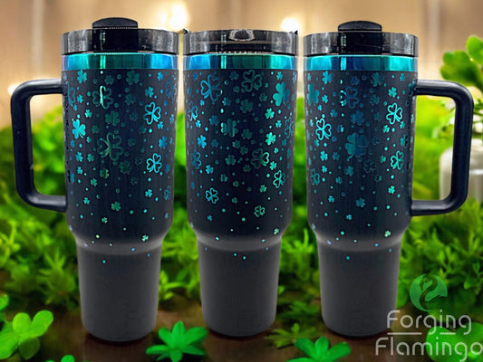 Composite image of a 40oz black tumbler with green engraving, featuring Forging Flamingo's Showered with Luck design. Shown from multiple angles to highlight scattered shamrocks and playful St. Patrick's Day charm in a seamless festive wrap. Part of our Bargain Bin collection.