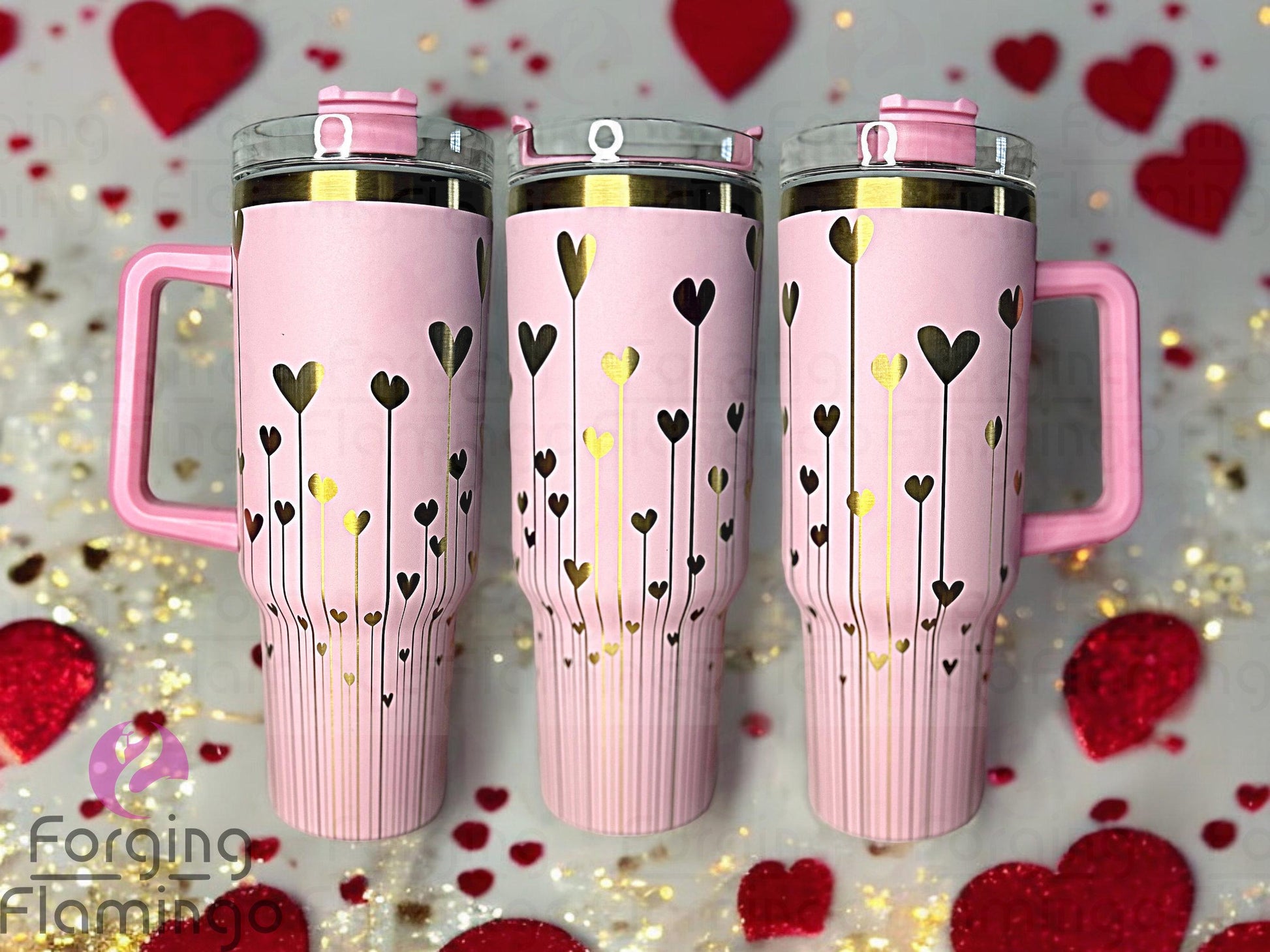 Composite image of a 40oz light pink tumbler with gold engraving, featuring Forging Flamingo's String of Hearts design. Shown from multiple angles to highlight dangling heart shapes strung like garland in a seamless romantic wrap. Part of our Bargain Bin collection.