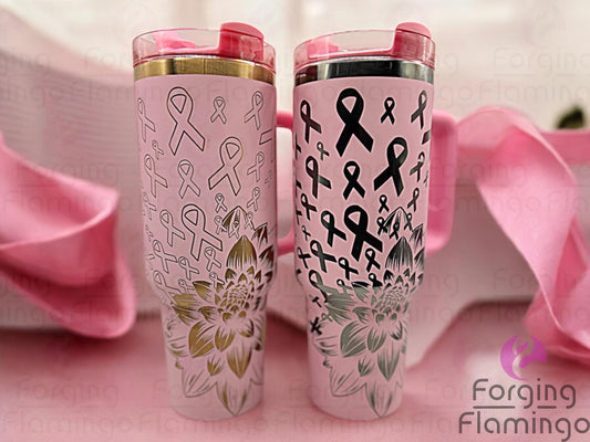 Composite image showing two Non-Branded tumblers side by side, engraved with Forging Flamingo's Dahlia Pink Ribbon design, one featuring outlined ribbons with a gold base, the other showing filled-in ribbons with an onyx base‚ highlighting floral breast cancer awareness details.