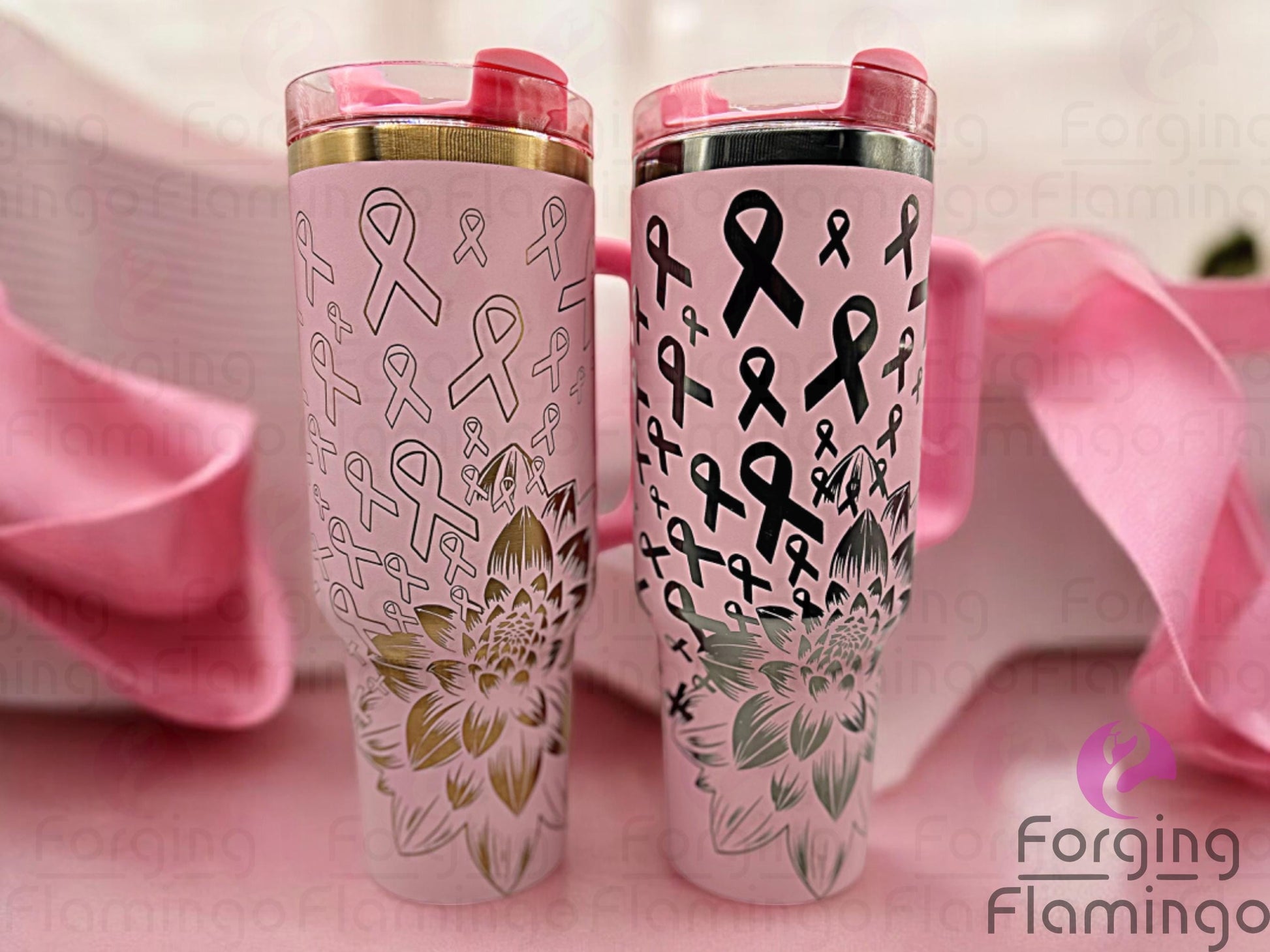 Composite image showing two Stanley tumblers side by side, engraved with Forging Flamingo's Dahlia Pink Ribbon design‚ one featuring outlined ribbons with a gold base, the other showing filled-in ribbons with an onyx base‚ highlighting floral breast cancer themes.