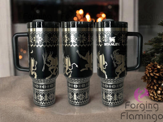 Composite image of a black glow Stanley tumbler engraved with Forging Flamingo's Krampus Ugly Christmas Sweater design, shown from multiple angles to highlight festive sweater patterns with Krampus faces, snowflakes, and holiday icons in a seamless wrap.